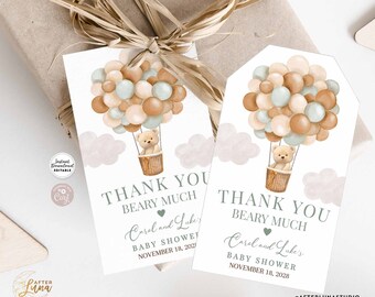 May include: Two thank you tags with a teddy bear in a hot air balloon made of brown and green balloons. The text on the tags reads "Thank You Beary Much Carol and Luke's Baby Shower November 18, 2028".