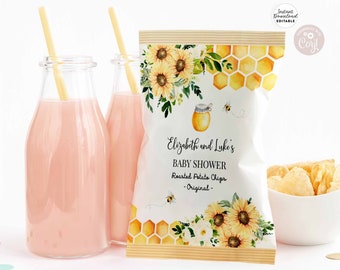 May include: A white chip bag with a honeybee theme. The bag has a yellow and white honeycomb pattern, sunflowers, and a honey jar with a bee. The text on the bag reads "Elizabeth and Luke's Baby Shower Roasted Potato Chips - Original - "
