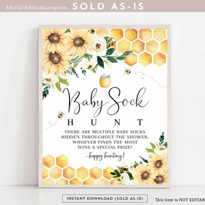 May include: A framed sign with a floral and honeycomb design, featuring sunflowers and bees. The sign reads "Baby Sock Hunt" with instructions for a baby shower game. The sign is a digital download.
