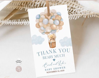May include: Thank you beary much baby shower favor tag with a teddy bear in a hot air balloon made of blue and beige balloons. The tag says "Thank you beary much Carol and Luke's Baby Shower November 18, 2028".