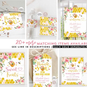 May include: A set of printable party decorations featuring a bee and honeycomb theme. The decorations include a welcome sign, thank you tags, a time capsule sign, and a sweet treats sign. The decorations are decorated with pink flowers and bees.