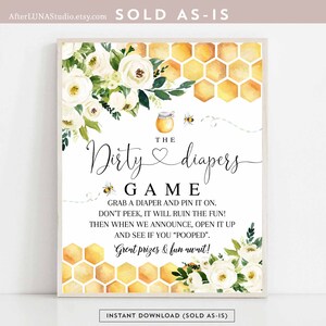 May include: A printable game card for a baby shower with a honeycomb pattern and white flowers. The text reads "The Dirty Diapers Game. Grab a diaper and pin it on. Don't peek, it will ruin the fun! Then when we announce, open it up and see if you "pooped". Great prizes & fun await!"
