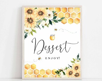 May include: A printable sign with a white background and a honeybee theme. The sign features a honey jar, bees, sunflowers, and white flowers. The text on the sign reads "Dessert Enjoy!"  Instant Download (Sold As-Is). This item is not editable.