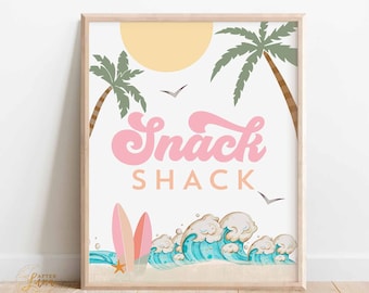 May include: A framed print with a beach theme. The words "Snack Shack" are in pink, with a sun, palm trees, and waves. Two surfboards and a starfish are also featured. The print is in a wooden frame.