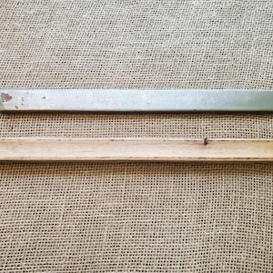 May include: A white ceramic mug with a black handle and the text "But First, Coffee" in a black, handwritten-style font. The mug is on a white surface.