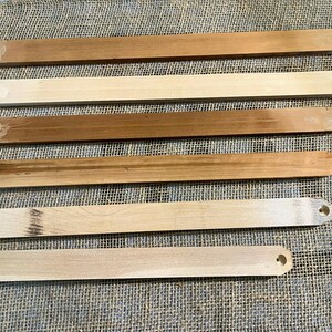 May include: A set of three ceramic mugs with a speckled, matte finish. The mugs are in shades of cream, light gray, and dark gray. Each mug has a simple, minimalist design, perfect for coffee or tea.