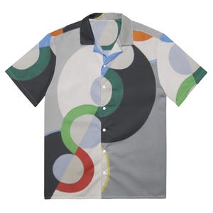 May include: A short-sleeved button-up shirt with a geometric pattern of overlapping circles in shades of green, blue, red, and grey.