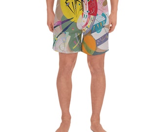 May include: Abstract art print swim trunks with a white, yellow, green, blue, red, and orange color scheme. The print features geometric shapes and lines.