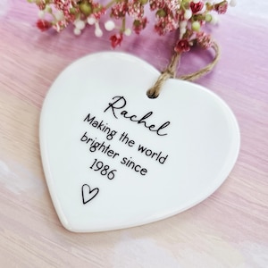 Personalised birthday ceramic heart hanging decoration with custom name and year, thoughtful keepsake gift for mum, sister, friend or best friend.