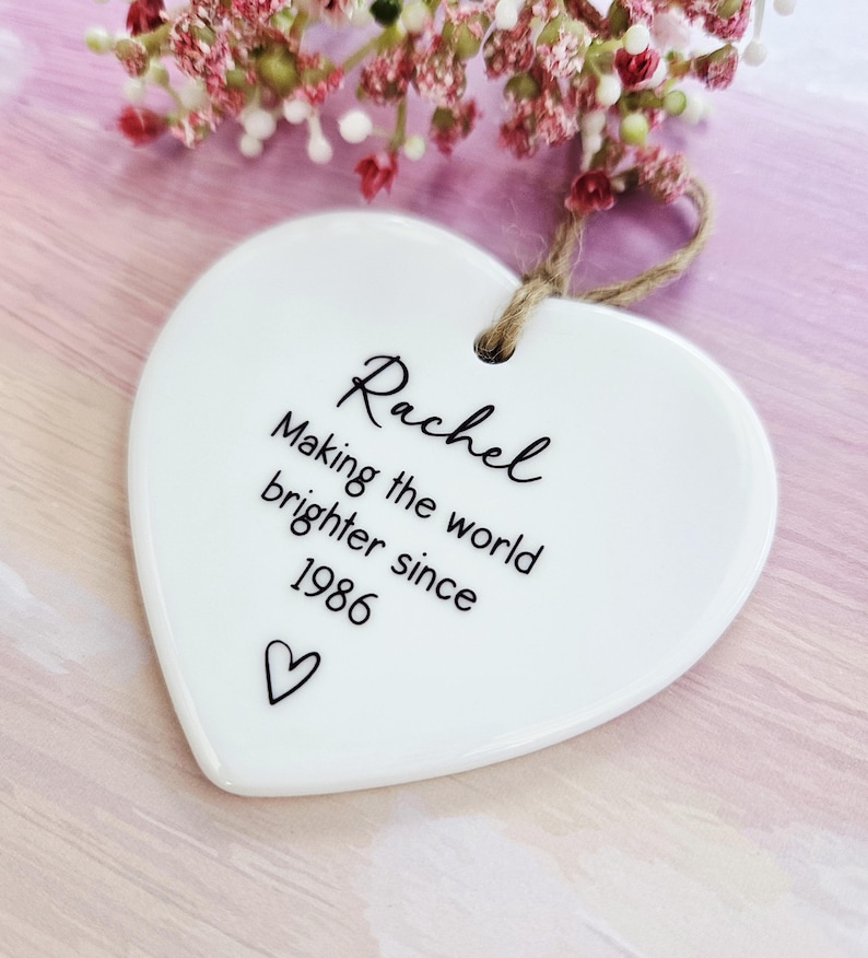 Personalised birthday ceramic heart hanging decoration with custom name and year, thoughtful keepsake gift for mum, sister, friend or best friend.