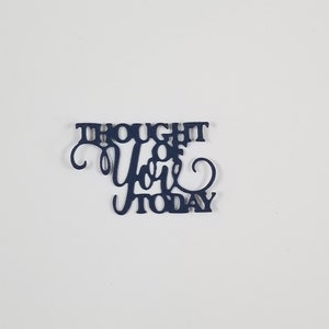 May include: Black paper cutout with the text "Thought of you today" in a decorative font.