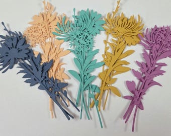 May include: A collection of colorful paper flower cutouts in shades of blue, peach, teal, yellow, and purple. Each flower has detailed leaves and stems, arranged in a fan-like display. The paper flowers are likely for crafting or decorative purposes.