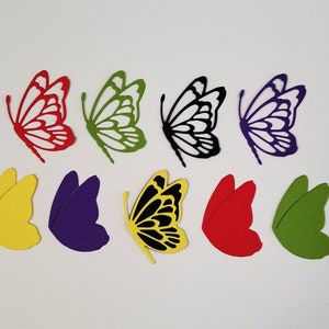 May include: A collection of colorful butterfly cutouts in various colors, including red, green, black, and purple. The butterfly wings are arranged in a visually appealing pattern, perfect for crafting or decorative projects.