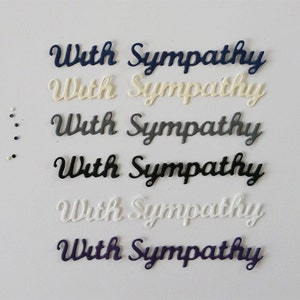 May include: A collection of die-cut paper phrases in various colors, each reading "With Sympathy" in a cursive font. Colors include navy, cream, gray, black, white, and purple. Small dots of matching colors are scattered on the left.