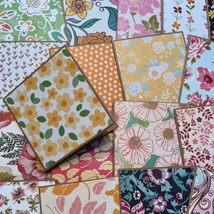 May include: A collection of 12 cards with various floral patterns. The cards are all different colors and have a variety of floral designs. Some of the cards have a brown border.