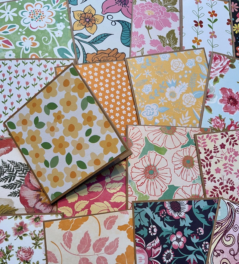 May include: A collection of 12 cards with various floral patterns. The cards are all different colors and have a variety of floral designs. Some of the cards have a brown border.