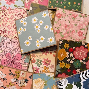 May include: A collection of 10 different floral patterned cards with brown borders. The cards feature a variety of floral designs, including daisies, tulips, and roses.