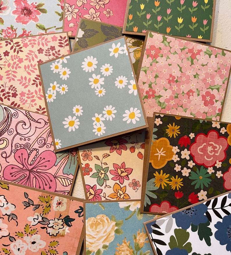 May include: A collection of 10 different floral patterned cards with brown borders. The cards feature a variety of floral designs, including daisies, tulips, and roses.