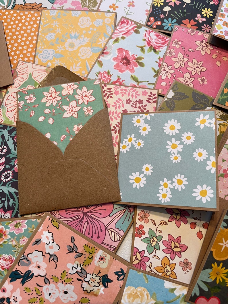May include: A collection of handmade cards with various floral patterns. The cards are made with different colors and textures, including pink, blue, green, and yellow. The cards are perfect for sending a special message to someone you care about.