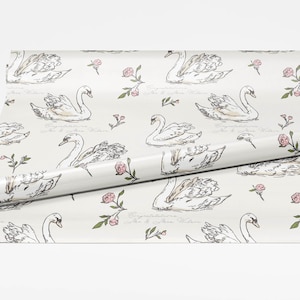 Roll of swan wrapping paper spread open on a white background showing full pattern repeat with ivory backdrop blush flowers and personalized wedding text option