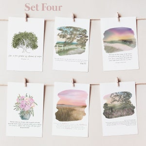 May include: Set of six printable cards with watercolor backgrounds and inspirational bible verses. The cards feature a tree, a field, a sunset, a flower arrangement, and a road. The verses are printed in black text on a white background.