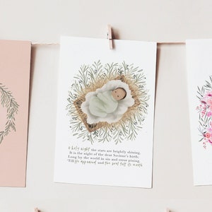 May include: Three printable Christmas cards with watercolor illustrations. The first card features a wreath with the word "hope" in the center. The second card features a baby in a manger with a green and brown floral wreath around it. The third card features a pink and green floral wreath with the text "Come, Thou long expected Jesus".