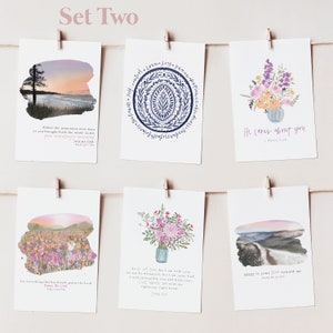 May include: Set of six inspirational cards with watercolor illustrations and bible verses. The cards feature a sunset landscape, a floral arrangement, a field of flowers, a floral arrangement, a mountain landscape, and a mandala design. The verses include "Before the mountains were born...", "He cares about you...", "Let everything that has breath praise the Lord...", "Do not be afraid, for I am with you...", "Great is your love toward me...", and "Love, joy, peace, patience, kindness, goodness, faithfulness, gentleness, self-control."