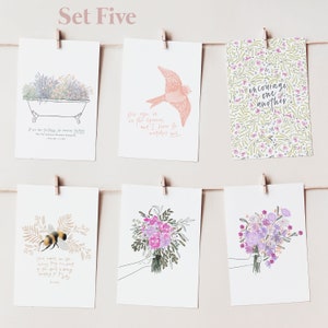 May include: Set of five cards with floral and nature-themed illustrations and inspirational quotes. The cards feature a bird, a bee, a bouquet of flowers, a bathtub with flowers, and a floral pattern with the text "encourage one another".