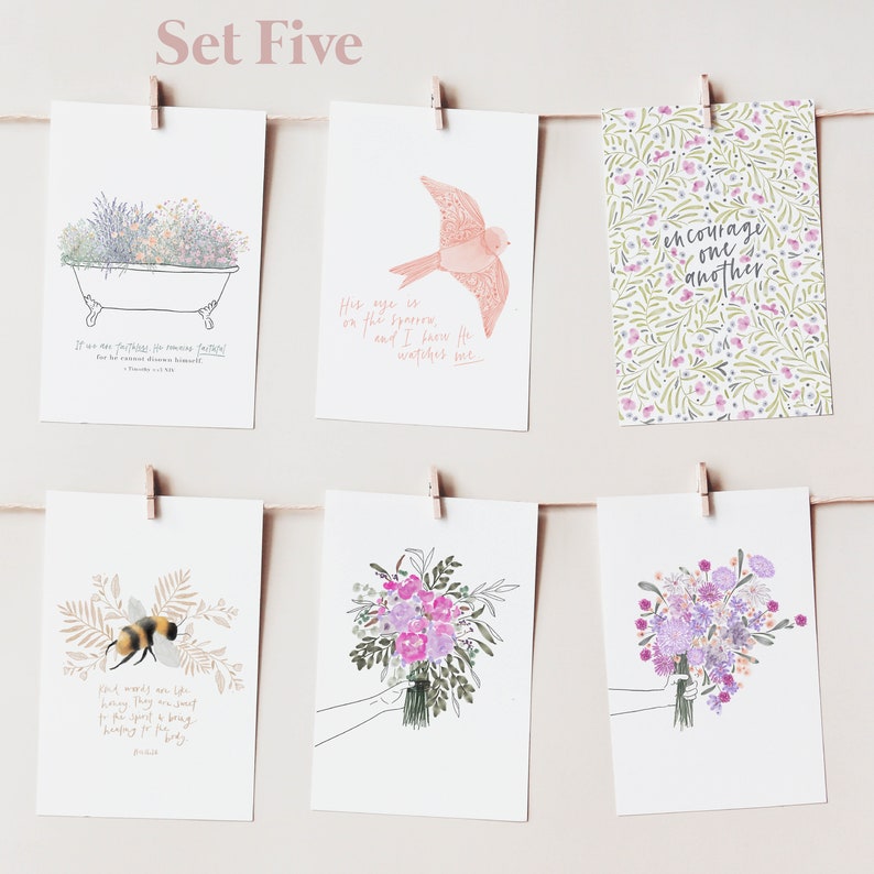 May include: Set of five cards with floral and nature-themed illustrations and inspirational quotes. The cards feature a bird, a bee, a bouquet of flowers, a bathtub with flowers, and a floral pattern with the text "encourage one another".