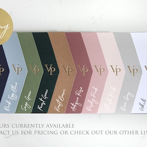 May include: A color palette featuring various shades, including navy blue, sage green, and antique rose. Each color sample has a gold foil "VP" logo. The words "Foiling" and color names are also in gold foil.