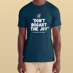 May include: A navy blue t-shirt featuring the white text "DON'T BOGART THE JOY" and a small graphic. Below the main text is the text "-SAPPER NARATE'S CUSTOM CREATIONS-".