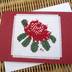 Hand cross stitched Australian native flora card - Waratah.  Red card with white envelope and white paper insert.