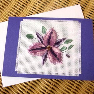 Hand cross stitched Australian native flora card - Fringe Lily.  Purple card with white envelope and white paper insert.