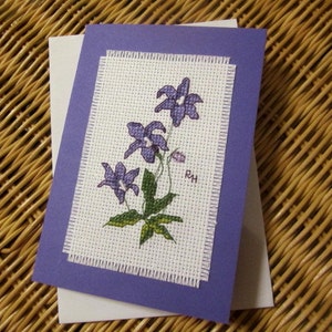 Hand cross stitched Australian native flora card - Royal Bluebell.  Purple card with white envelope and white paper insert.