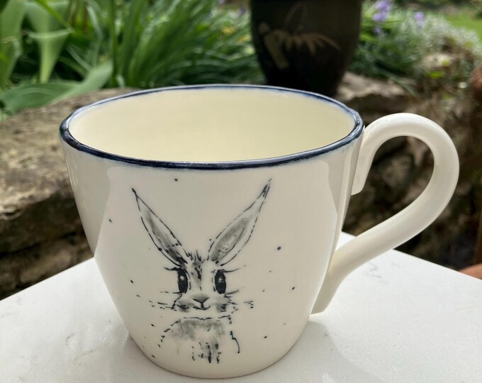Handmade hand painted white ceramic tea or coffee cup in with hand painted hare design free delivery