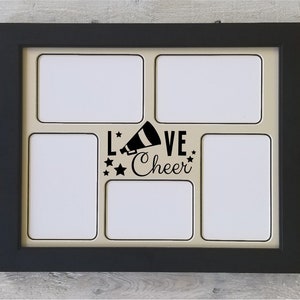 May include: Black picture frame with five white photo openings. The frame has a beige mat and a black and white graphic that says "Love Cheer" with a megaphone and stars.