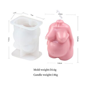 May include: A white silicone mold and a pink candle in the shape of a pregnant woman's body. The mold is 7 inches wide, 9.2 inches tall, and 5.3 inches deep. The candle is 4.5 inches wide, 8.5 inches tall, and 5.8 inches wide. Mold weight: 54.6g. Candle weight: 146g.