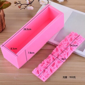 May include: A pink rectangular silicone soap mold, 10.4 inches long, 3.3 inches wide, and 3.1 inches deep, next to a pink silicone mold with a textured floral pattern, 9.6 inches long and 2.4 inches wide. The weight is 950 grams.