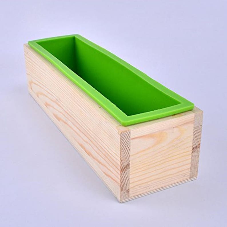 Pu&ograve; includere: Uno stampo per sapone in legno con un rivestimento in silicone verde. Lo stampo &egrave; in legno naturale e ha una forma rettangolare.