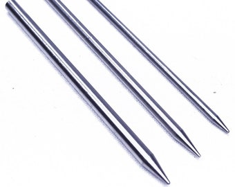 May include: Three silver metal knitting needles of different lengths.