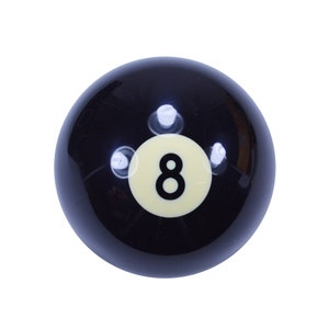 May include: Black billiard ball with a white number eight on it.