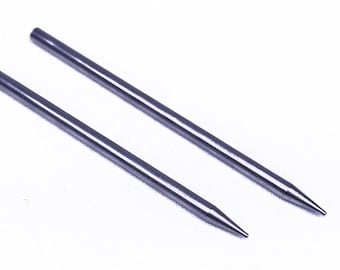May include: Two silver metal knitting needles with pointed tips.