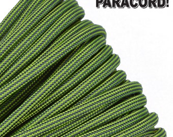 May include: Close-up of green and gray paracord, a type of strong nylon rope. The rope is coiled and has a checkered pattern.