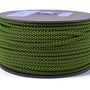 May include: A spool of green and black paracord with a diamond pattern. The paracord is wound tightly around the spool.