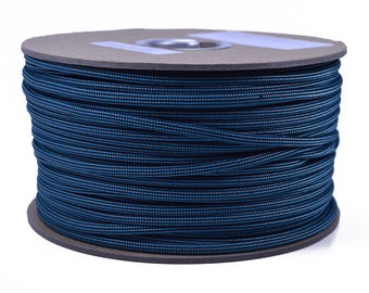 May include: A spool of dark blue paracord, a type of strong nylon rope, is wound tightly on a cardboard core.