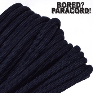 May include: A close-up of a spool of dark blue paracord. The paracord is tightly wound and has a textured surface. The text "BORED? PARACORD!" is visible in the upper right corner of the image.