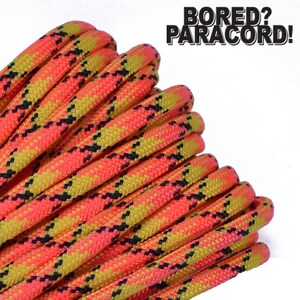 May include: Close-up of a spool of bright pink, yellow, and black paracord. The paracord is in a plaid pattern. The text "BORED? PARACORD!" is in the upper right corner of the image.