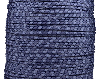 May include: A large spool of blue and gray patterned rope. The rope is tightly wound, displaying a repeating geometric design. The color scheme is a mix of dark and light blues, creating a textured appearance. The spool is on a cardboard base.