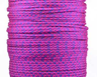 May include: A large spool of vibrant pink and blue paracord. The cord is tightly wound, showcasing a repeating pattern of pink and blue. The spool sits on a brown cardboard base, ready for crafting or outdoor use.