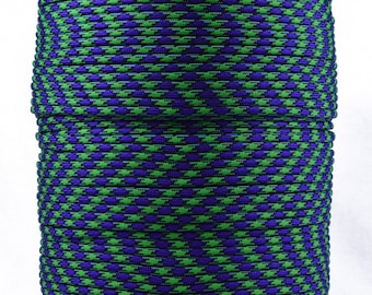 May include: A spool of green and purple paracord with a houndstooth pattern.